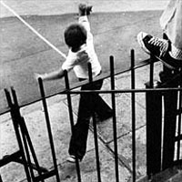 Boy throws ball against curb