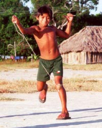 Boy playing with traditional top in northern Brazil